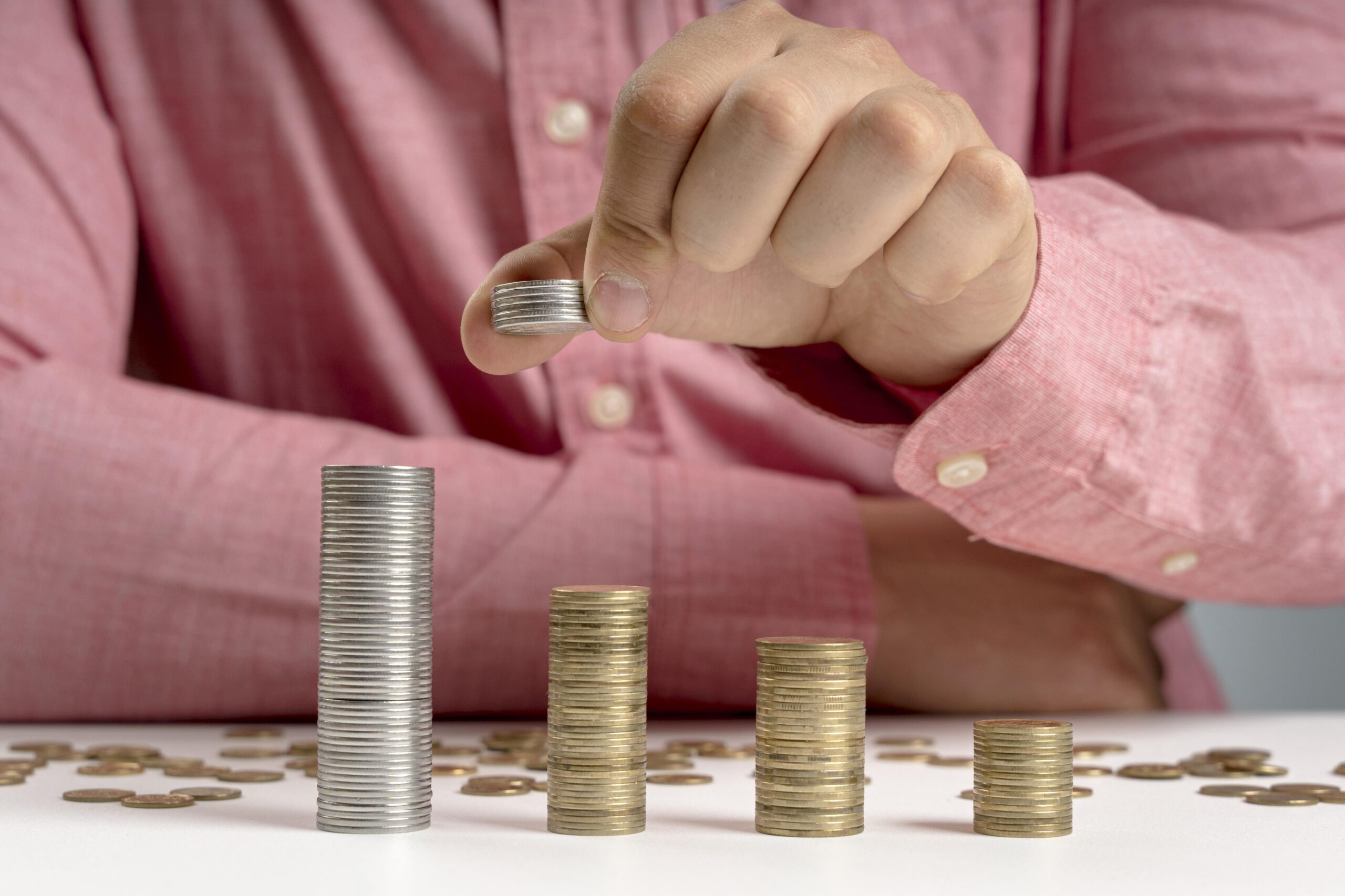 Man Arranging Stack Coins (2)